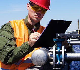 Technician checking wastewater odour control systems and monitoring hydrogen sulphide levels.